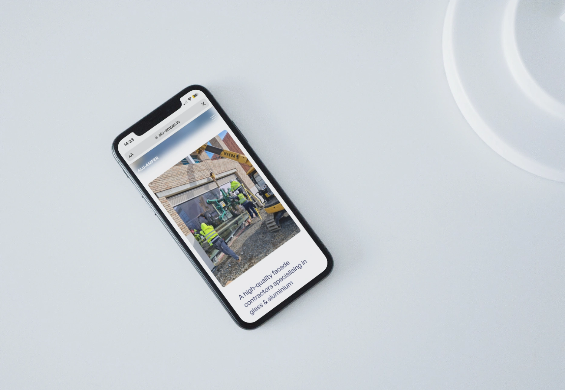 alu-amper-homepage-on-mobile-mockup-web-design